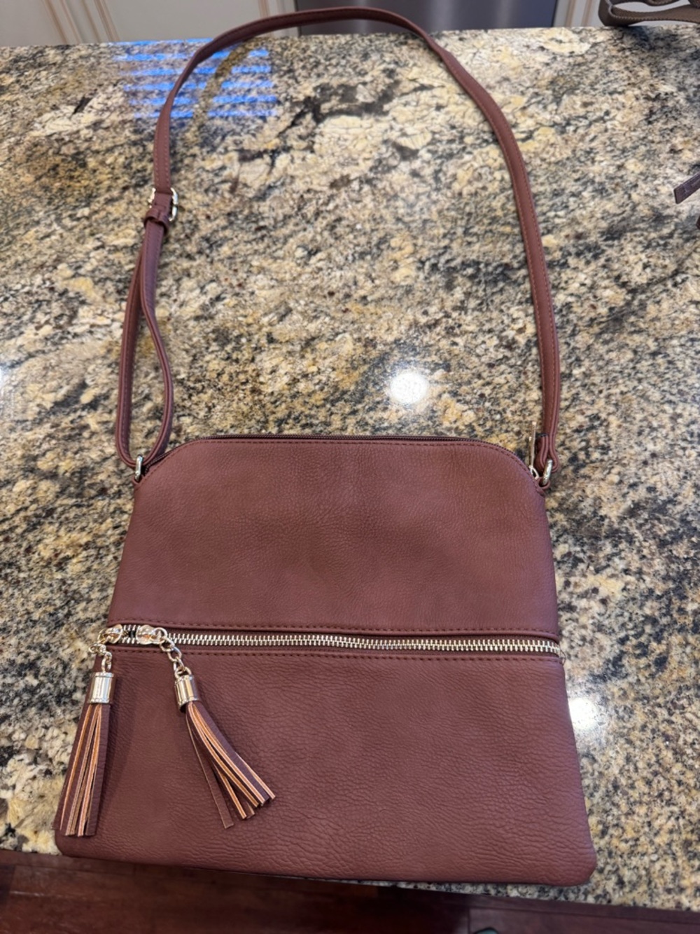 Women's Crossbody Bag in Brown with Tassel Accents in brown and gold.